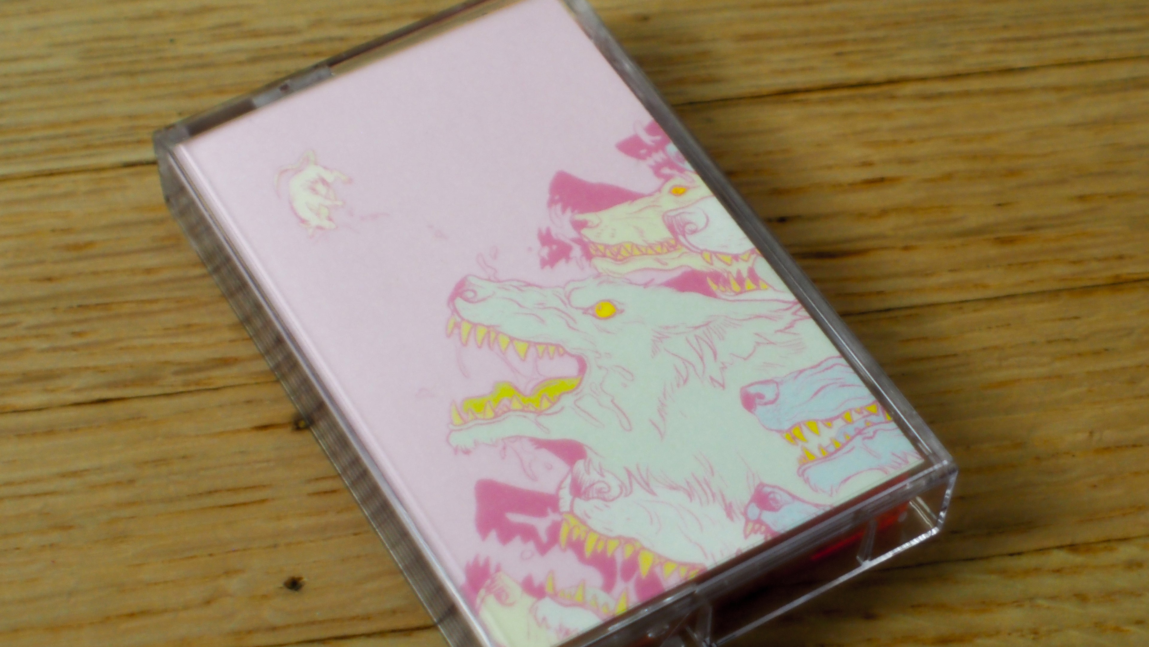 Cassette tape for "Shed Blood" with a colorful design on a wooden surface