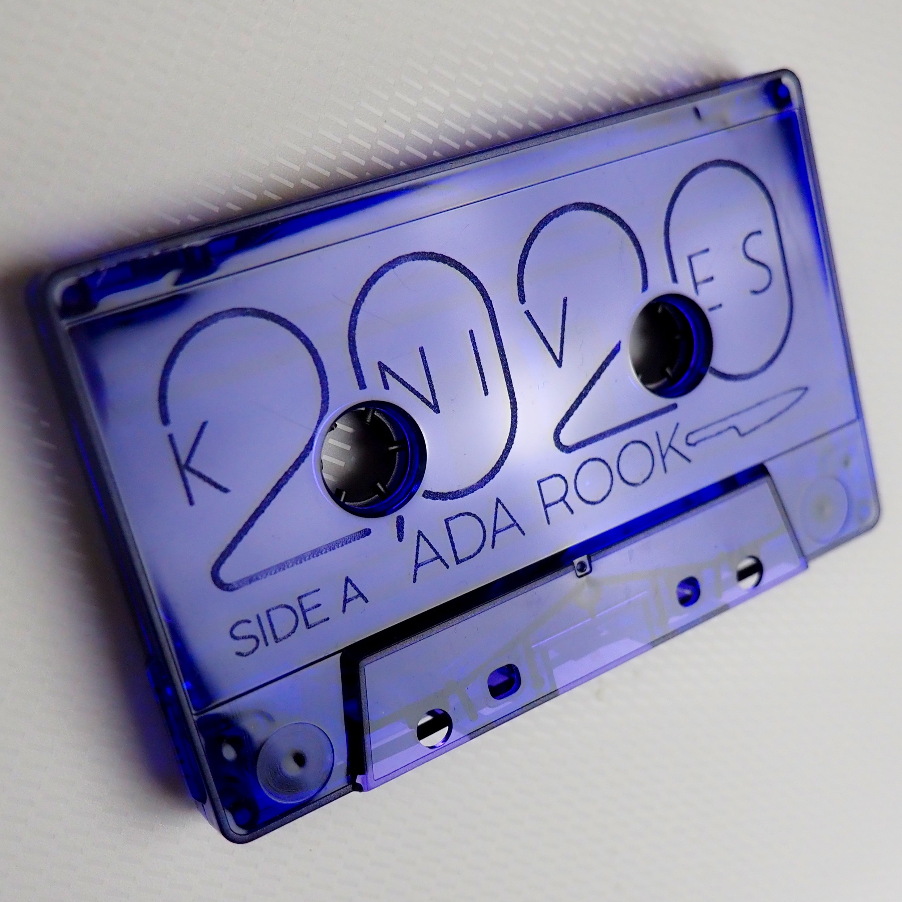 Blue cassette tape for '2020 Knives' on a white background