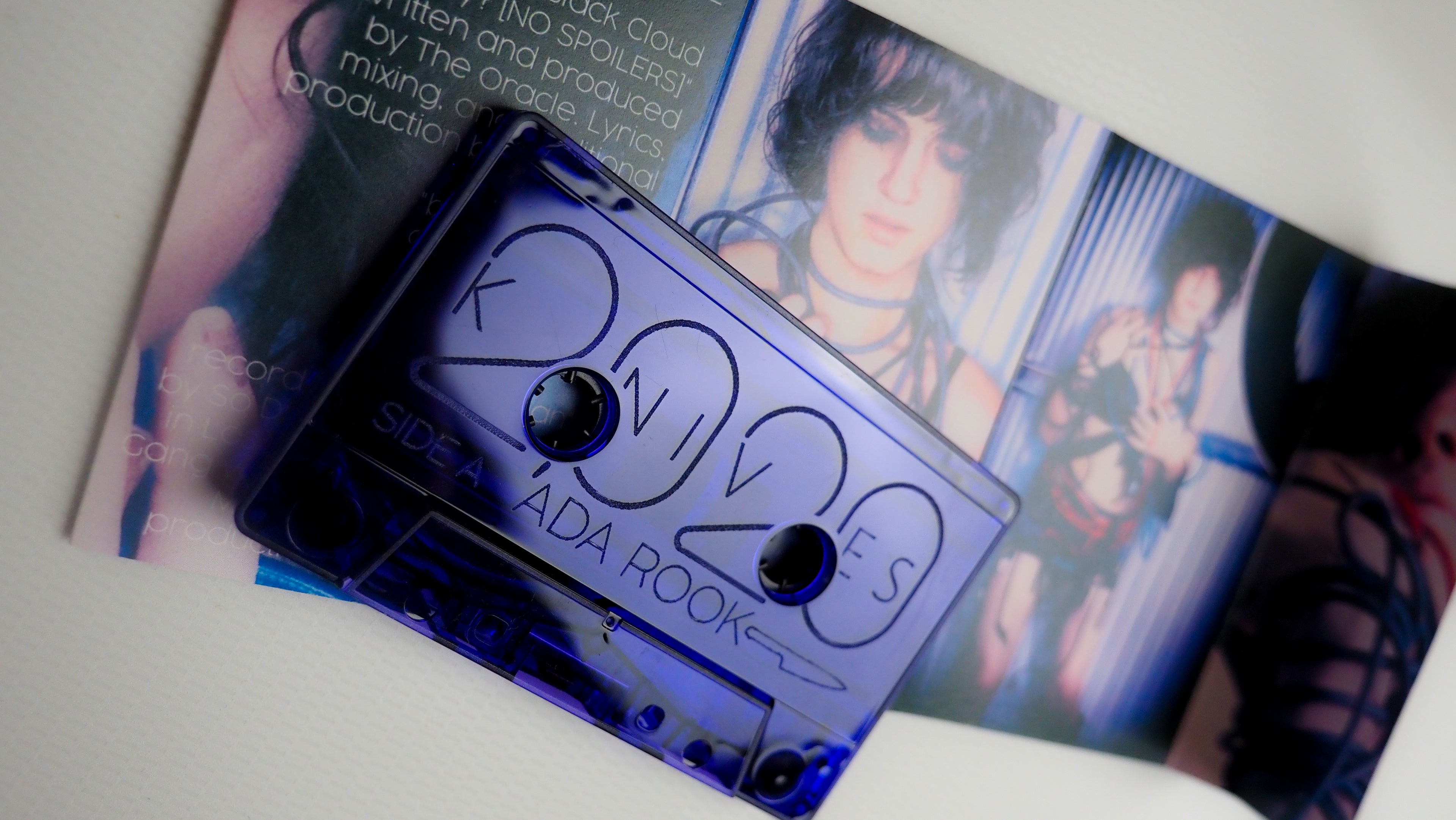 Cassette tape for '2020 KNIVES' atop the inner booklet