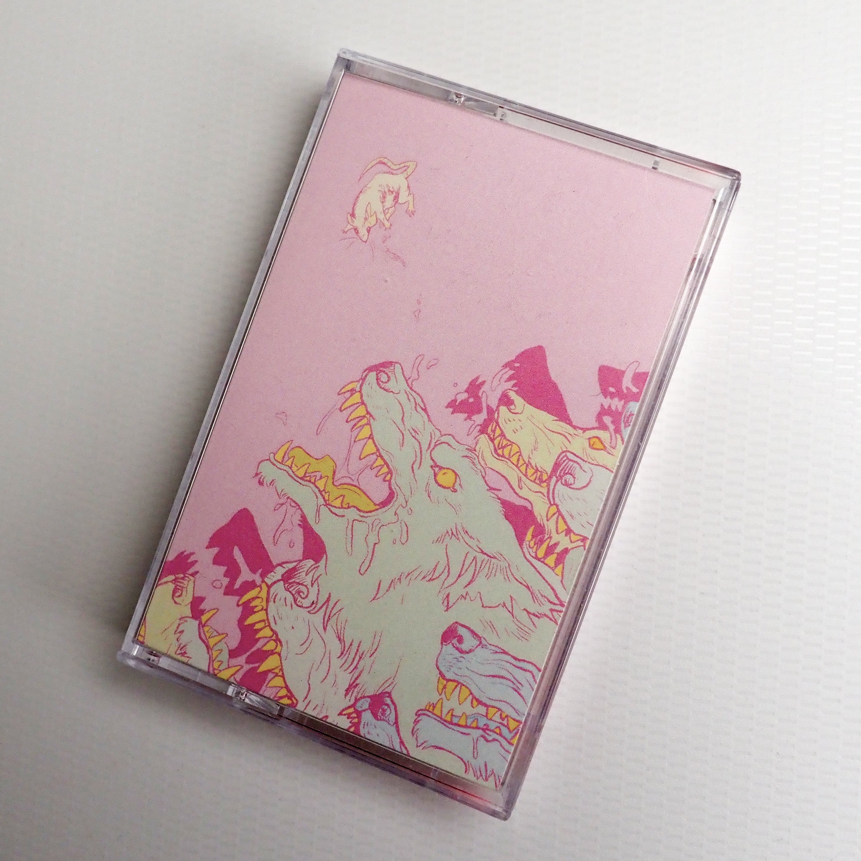 "Shed Blood" cassette tape case with a colorful wolf design on a pink background